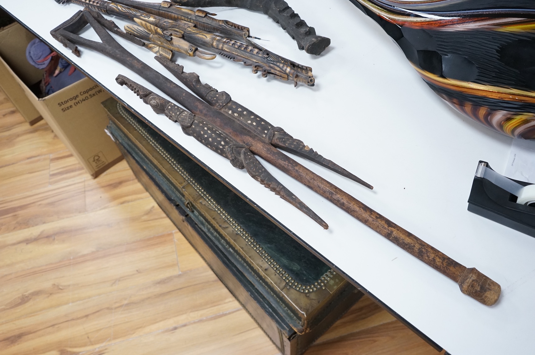 Two Papua New Guinea Sepik River carvings and a carved bone artefact, largest 92cm in length